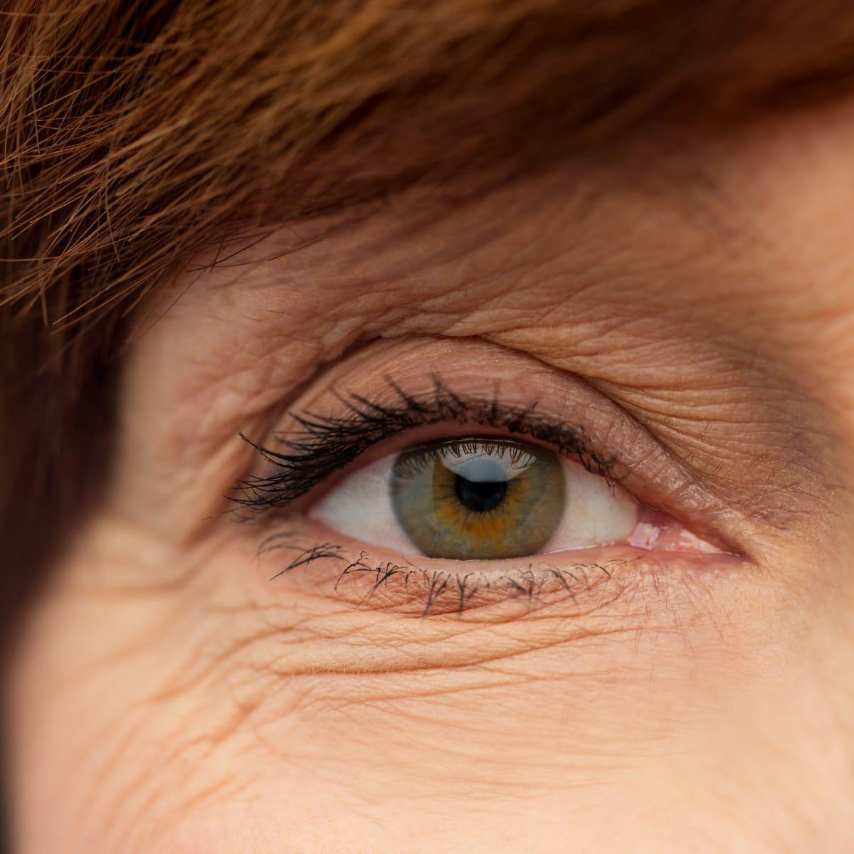 Close-up of an older woman's hazel eye and brow