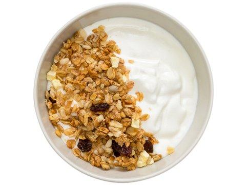 A bowl of plain Greek yogurt topped with homemade granola and raisins